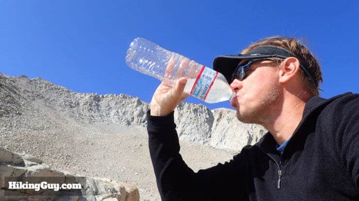cris hazzard drinks water on hike