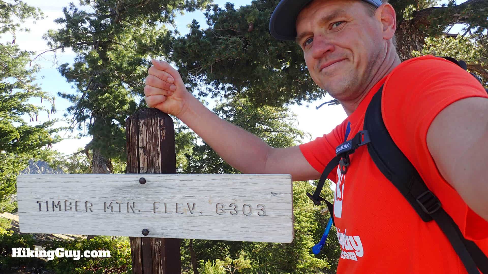 cris hazzard at the Timber Mountain summit sign